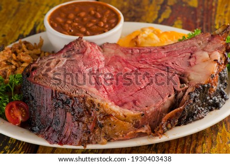 Prime Rib. Beef Prime Rib bbq. Beef rubbed in spices and seasoning and slow cooked in a smoke house with mesquite wood chips. Traditional barbecue Texas Smoke House beef prime rib. 