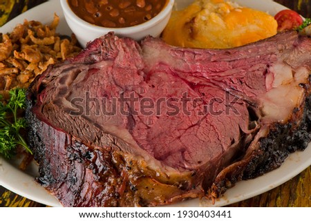 Prime Rib. Beef Prime Rib bbq. Beef rubbed in spices and seasoning and slow cooked in a smoke house with mesquite wood chips. Traditional barbecue Texas Smoke House beef prime rib. 