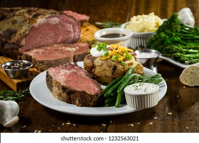 Prime Rib Meal Served On A Table With Ingredients Surrounding The Main Dish