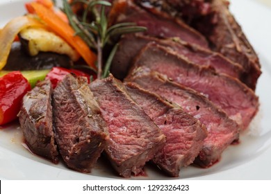 Prime Rib With Vegetables On White Plate Close Up. 