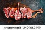 Prime steaks Black Angus on a wooden board: Tomahawk steak, Ribeye, T-bone and Ossobuco. A set of steaks for grilling. Top view.