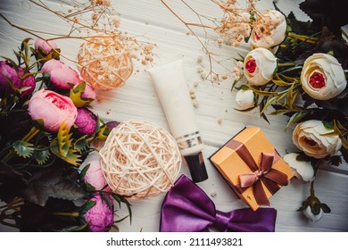 Primer For Makeup And Flowers On Wood White Background With Gift In Spring