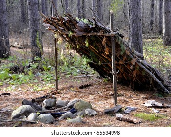 Primitive Shelter In The Woods With A Fire Pit 