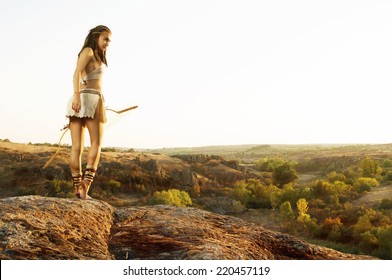 Primitive Woman  Holding A Bow. Amazon Woman