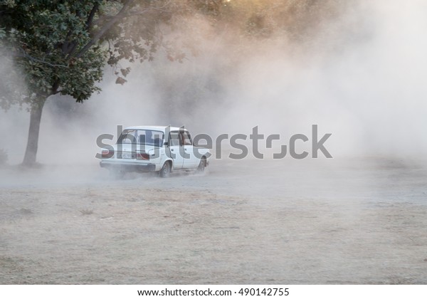 Primorsko - Septembar 10:\
Drifting a car raises clouds of dust on September 10, 2016,\
Primorsko, Bulgaria