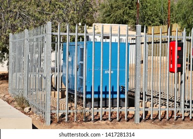 Prince Albert, South Africa - June 2, 2019: A Diesel Electric Generator Surrounded By A Steel Fence. Electricity Load Shedding Concept Image. 