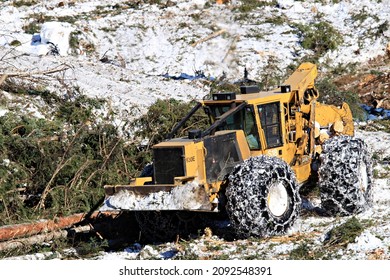 Prince George, British Columbia, Canada - February 26, 2021: Active logging operations showing skidders moving trees.