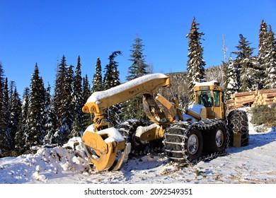 Prince George, British Columbia, Canada - February 15, 2021: Active logging operations showing parked skidders along the roadside.