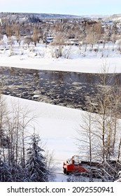 Prince George, British Columbia, Canada - February 2, 2021: A Train Goes By On A Nearby Track With The City Of Prince George In The Distance.