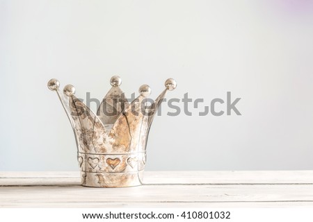 Princess crown with hearts on a wooden table