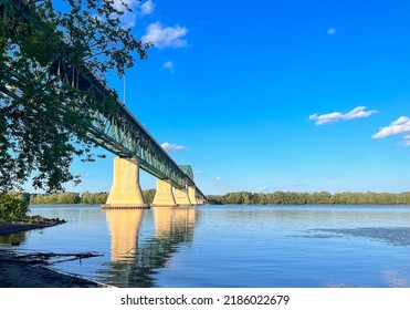 The Princess Margaret Bridge Over The Saint John River In Fredericton, New Brunswick Canada On A Sunny Evening  With Calm Water