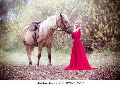Princess in red dress with horse in fall, autumn. Fairy tale, fantasy.