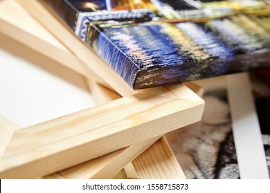 Print photography on canvas. Colorful photo, stack of wooden stretcher bars. Stretched photo canvas with gallery wrapping method, closeup, side view