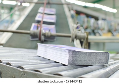 Print shop (press printing) - Finishing line. Post press finishing line machine: cutting, trimming, paperback and binding