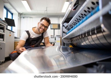 Print Worker Working On Computer To Plate Machine In Printing Shop.