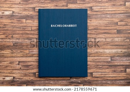 Printed and bound Bachelorarbeit (bachelor thesis) in Germany. Book with a blue cover to graduate from a German university with a bachelor degree. Finish studies with a project.