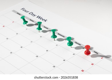 Printed calendar for a 4 day working week showing weekend days in red in new approach to productivity - Shutterstock ID 2026351838