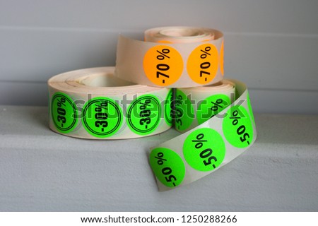 Printed colorfull sticker rolls on gray background.