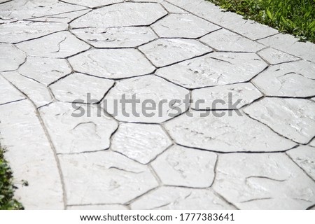 Printed grey concrete path compass