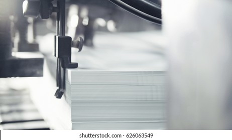 Printed sheets of paper are served in the printing press. Offset , CMYK - Shutterstock ID 626063549