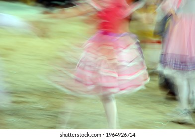 Printed And Very Colorful Round Skirts During Dance At Festa Junina Or June Party Translated Into English. Blur Background.