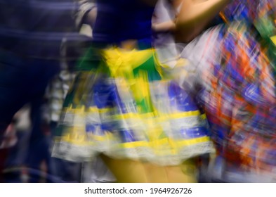 Printed And Very Colorful Round Skirts During Dance At Festa Junina Or June Party Translated Into English. Blur Background.