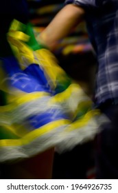 Printed And Very Colorful Round Skirts During Dance At Festa Junina Or June Party Translated Into English. Blur Background.