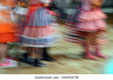 Printed And Very Colorful Round Skirts During Dance At Festa Junina Or June Party Translated Into English. Blur Background.