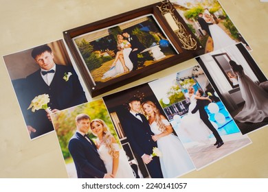 printed wedding photos and a wooden box with a flash drive. the concept of preserving the memory of an important event, the services of a professional photographer for the celebration.