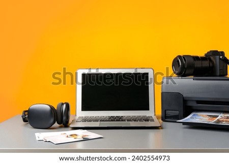 Printer, laptop and camera on table close up. Printing photos