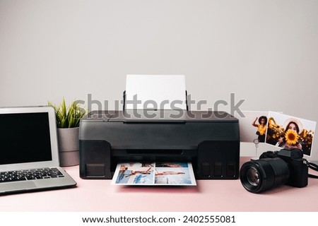 Printer, laptop and camera on table close up. Printing photos