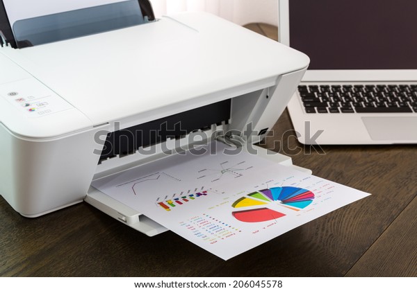 printer and Laptop on wood
table