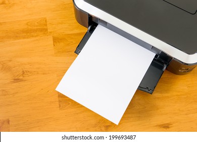 Printer And Paper On Wooden Board