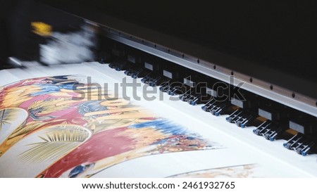 A printer is printing a colorful design on a piece of paper. The design features a variety of shapes and colors, including a large flower and a bird. Scene is vibrant and lively, with the colors