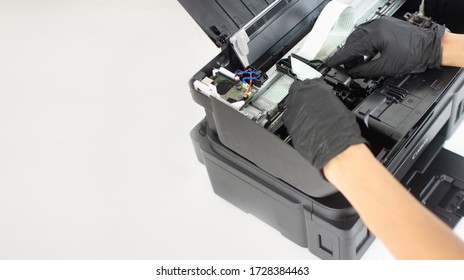 Printer repairman inspecting printer interior.Copy space. Concept of professional printer maintenance Technical assistance in office hardware Continuous repair of the ink system. Printer problems ..