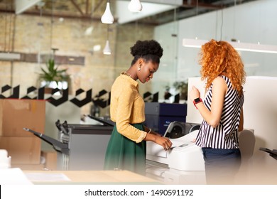 Printing Documents. Two Office Workers Working In Publishing Agency Printing Documents