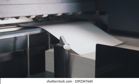 Printing Press Machine Takes Sheet Of Paper In Action In The Printing Production Line