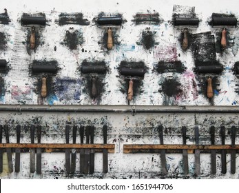 Printmaking Rollers Hanging On An Art Studio Wall In The Messy Workshop