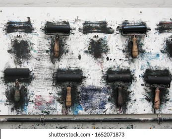 Printmaking Rollers Hanging On An Art Studio Wall In The Messy Workshop