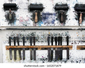 Printmaking Rollers Hanging On An Art Studio Wall In The Messy Workshop