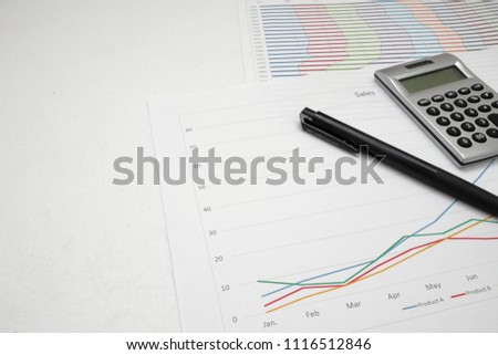 printout paper (graph) with calc and pen on desk