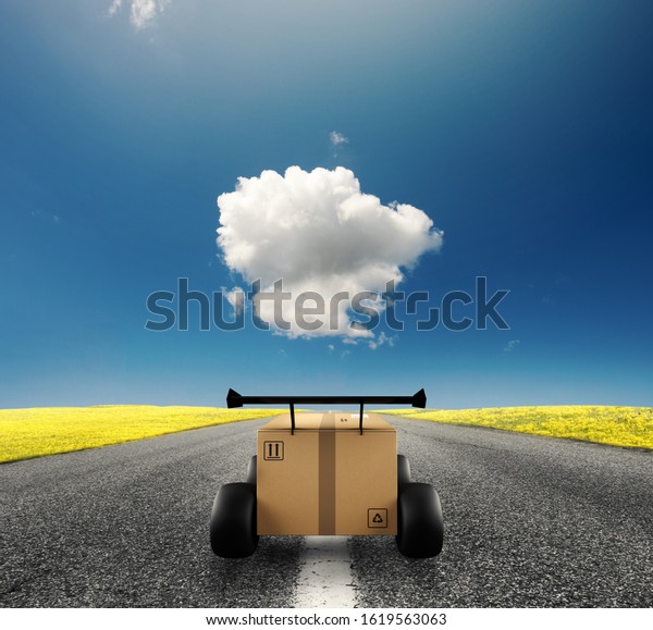 Priority Cardboard box with racing wheels like a
car. Fast shipping by
road.