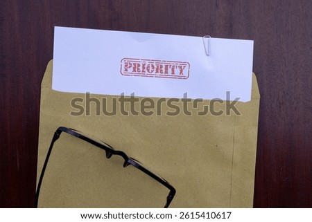 Priority Mail Visual: Document in Envelope on Brown Wooden Surface