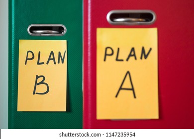 Priority of plan b, instead of a. Two folders with notes on stickers. Business planning. A spare option. Difficulties of enterprise management. Decision making. Foreground in blur.