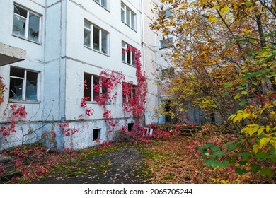 Pripyat, Ukraine - September 26, 2021: View of the lower part of the facade of a high-rise building in an abandoned ghost town.