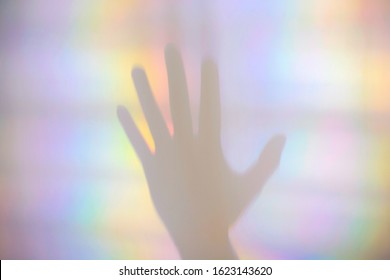 Prism rainbow light and shadow of a hand - Powered by Shutterstock