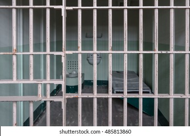 Prison cell with bed and toilet, no prisoner
