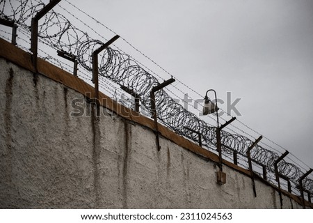 Prison fence. Barbed wire. Prison fence with barbed wire.