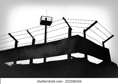 Prison fence with barbed wire, black and white grunge version