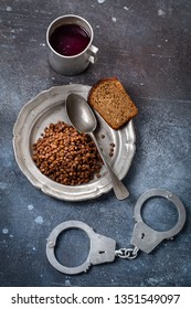 Prison Food And Handcuff In A Grunge Setting. Poor And Lacking Nutrition